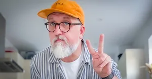 a kitchen selfie with me giving peace fingers wearing my lovely orange vaga hat