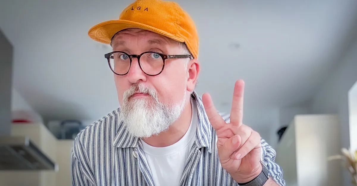 a kitchen selfie with me giving peace fingers wearing my lovely orange vaga hat