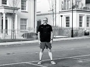 stu stands in the street after a run