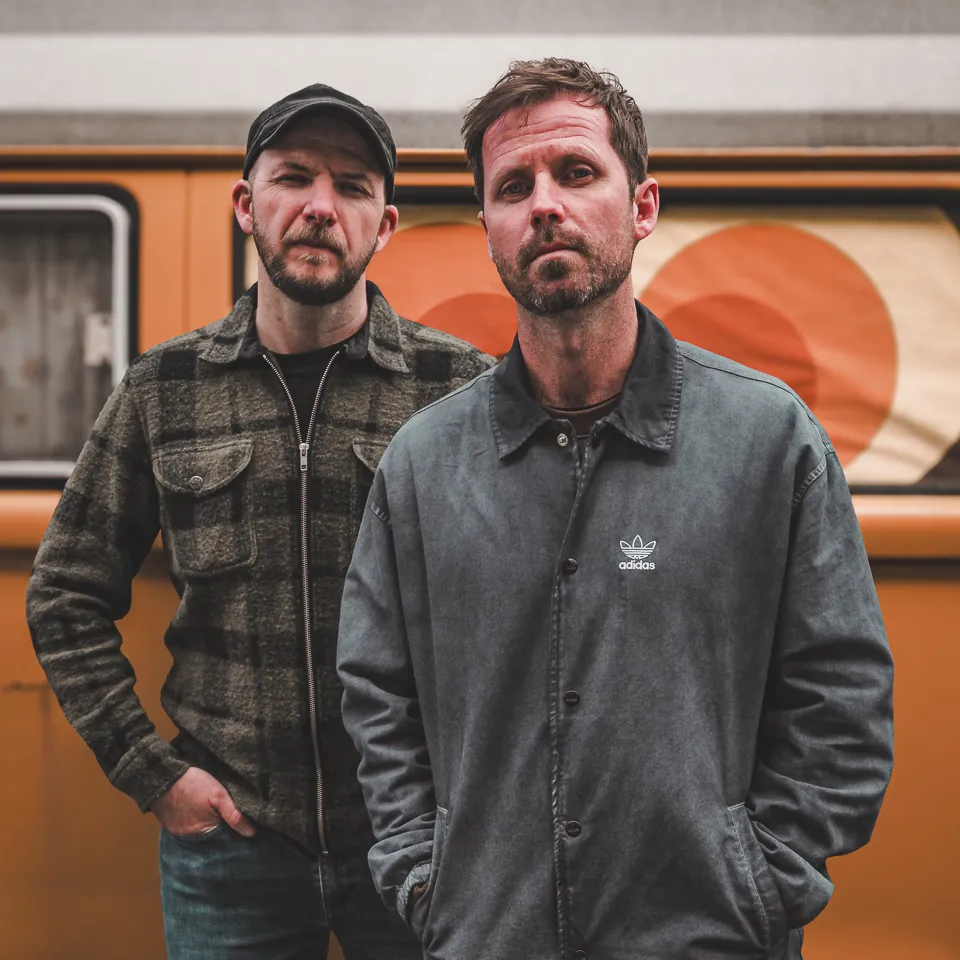 Portrait of Tommy and Darren by an orange van